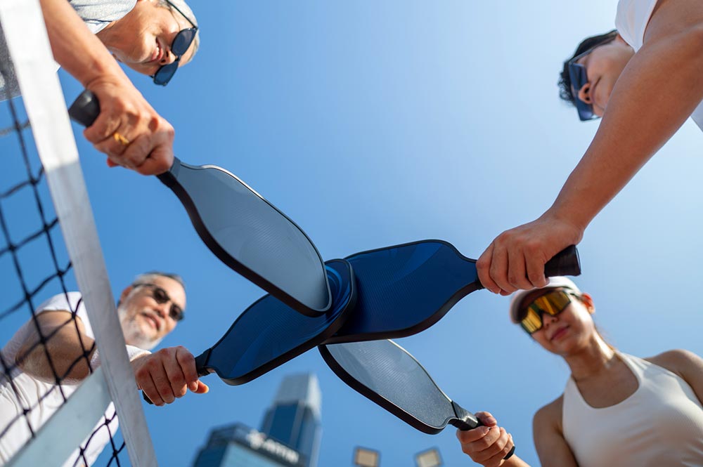 Pickleball Players Touching Paddles